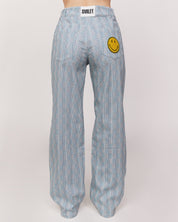 checkered pants with smiley face patch