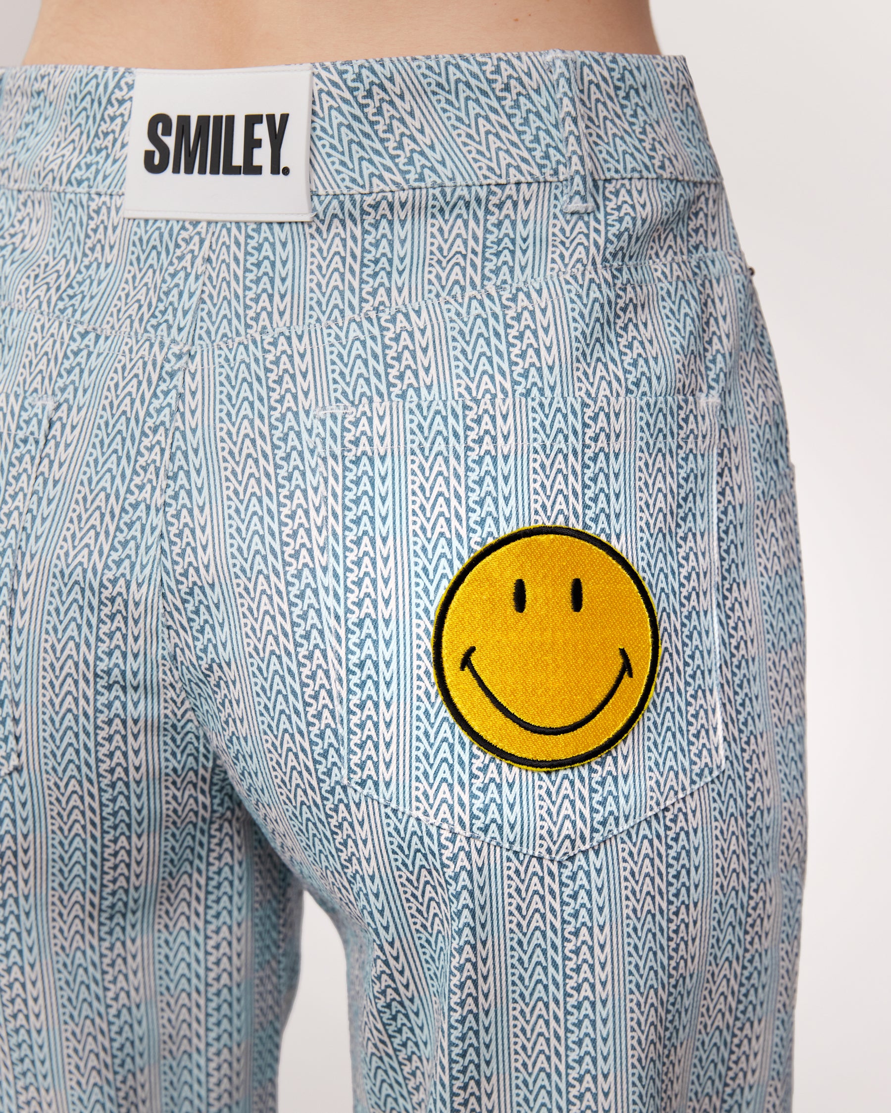 checkered pants with smiley face patch