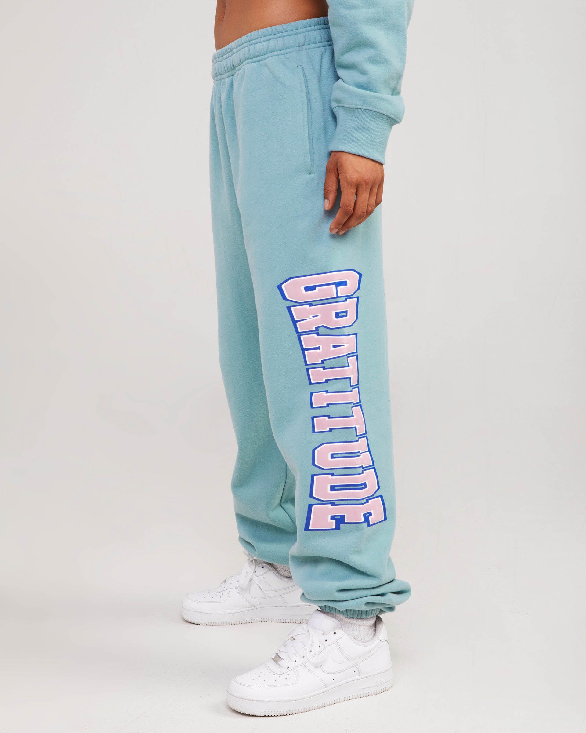 teal sweatpants with gratitude graphic