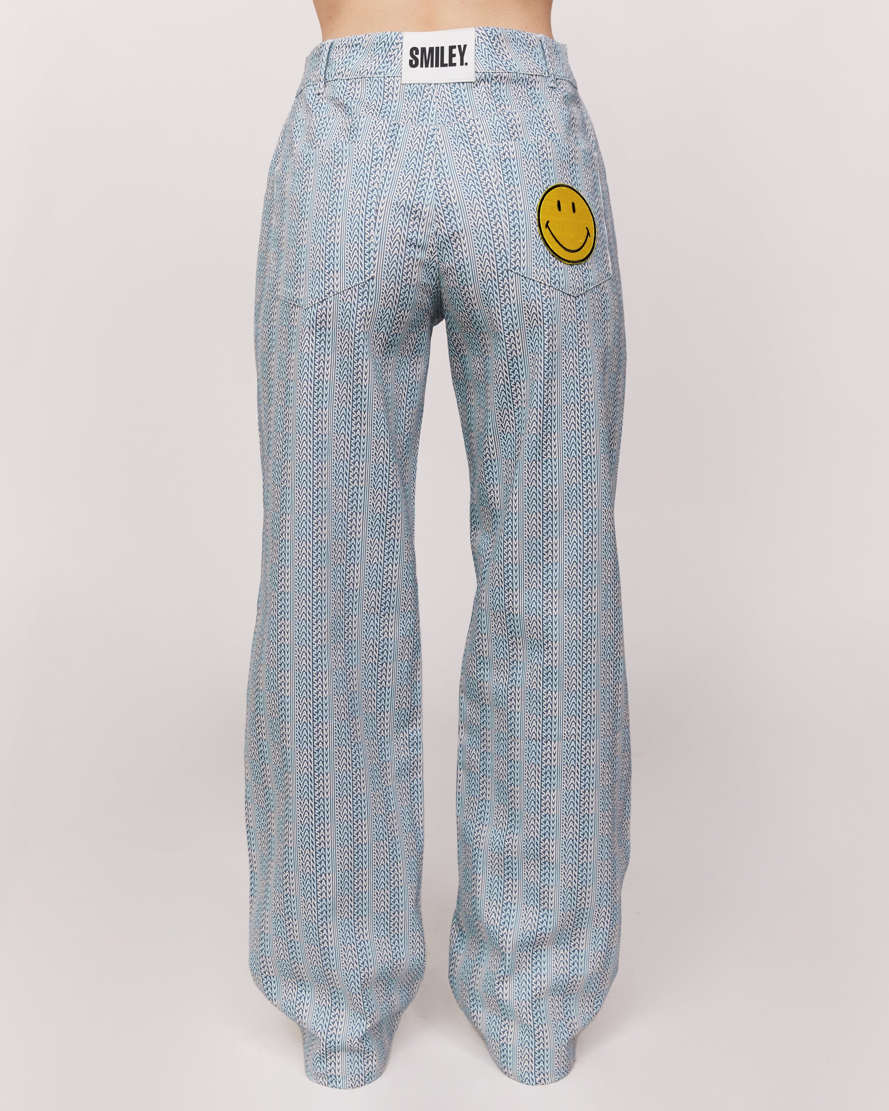 checkered pants with smiley face patch