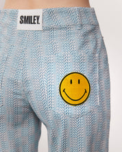 checkered pants with smiley face patch